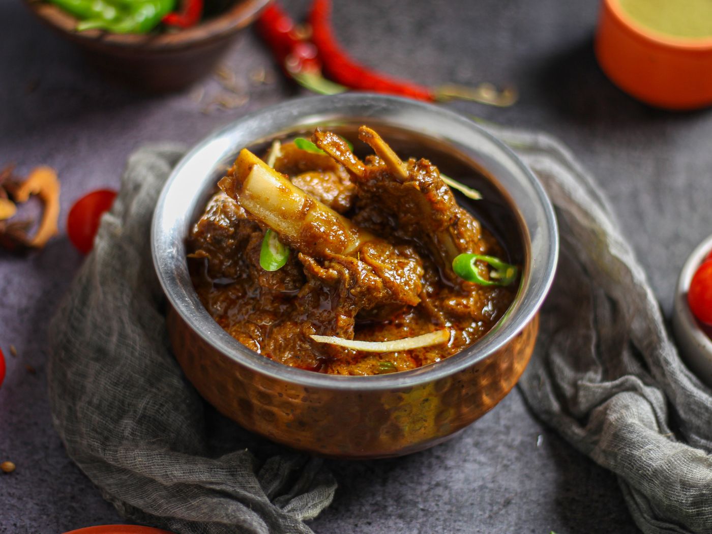 Bone-in curry goat in deep brown-gold curry gravy