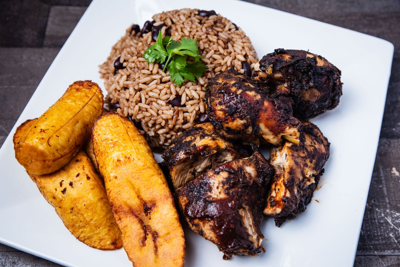 Jerk chicken dinner with rice and peas and fried plantains